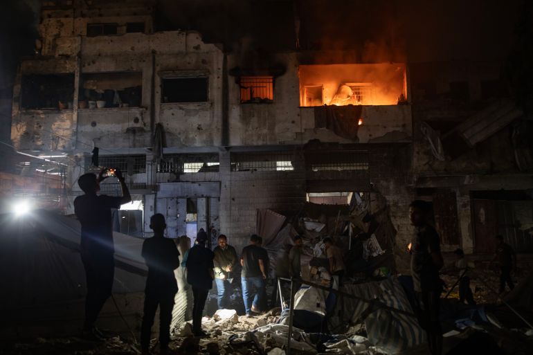 epa12998886 Palestinians inspect the site of an Israeli strike on a residential building sheltering displaced people in Gaza City, 27 May 2026. The strike left a number of people dead and injured. EPA/HAITHAM IMAD
