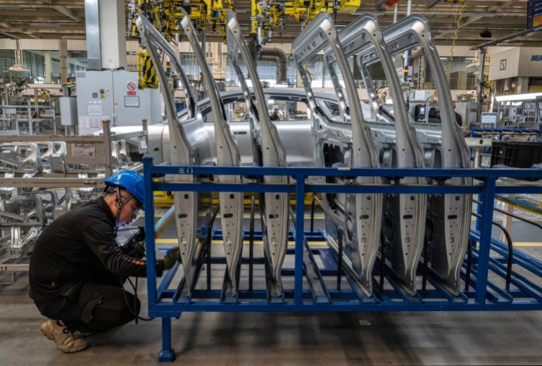 getty_69048cc0c3-1761905856 NINGBO, CHINA - MAY 29: A worker checks car parts on the production line for electric vehicle maker Zeekr at its factory on May 29, 2025 in Ningbo, China. China's automakers account for nearly two-thirds of global sales of electric vehicles and exports more vehicles overseas than any other country. Zeekr, a pure-electric brand aimed at the luxury market, has seen sales growth in the highly competitive Chinese market and is furthering its expansion into Asia, the Middle East, Latin America, and parts of Europe. The company's plans to enter the US market has faced hurdles due to tariffs on China made electric vehicles. In 2024, Zeekr delivered more than 220,000 vehicles, according to the company. Zeekr is among several Chinese EV makers building vehicles in automated factories using robotics powered by artificial intelligence alongside human workers. Zeekr is owned by Geely Holdings, which also has ownership stake in a number of foreign brands including Volvo, Lotus, and Polestar. (Photo by Kevin Frayer/Getty Images)