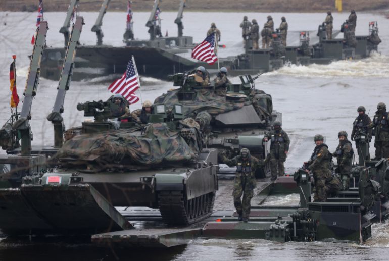 getty_698c70fd48-1770811645 GNIEW, POLAND - MARCH 05: M1A2 Abrams main battle tanks of the U.S. Army ride on M3 amphibious rigs of the German/British Amphibious Engineer Battalion 130 while crossing the Vistula River during the NATO Dragon 24 military exercise on March 05, 2024 near Gniew, Poland. Dragon 24 is involving troops from 10 different nations and is part of Steadfast Defender, an ongoing set of NATO military manoeuvres across Europe that is involving 90,000 troops. (Photo by Sean Gallup/Getty Images)