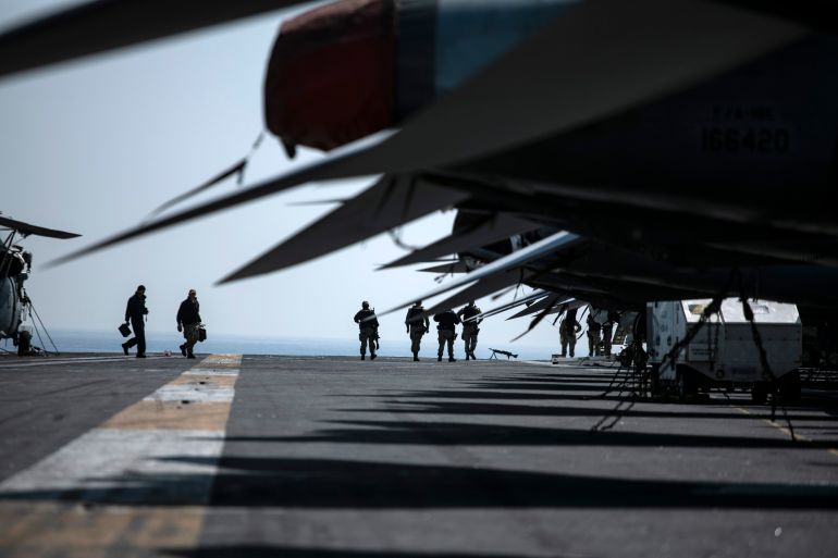 BUSAN, SOUTH KOREA - MARCH 28: Crew members walk by aircrafts aboard the U.S. Navy aircraft carrier, USS Nimitz, anchored in Busan Naval Base on March 28, 2023 in Busan, South Korea. The nuclear-powered USS aircraft carrier Nimitz docked in Busan, 390 kilometers south of Seoul, to conduct a joint Warrior Shield exercise taking place around the Korean Peninsula. The name Warrior Shield stands for the South Korea-US Alliance's ability and resolution to solidify their combined defense posture to defend South Korea. (Photo by Woohae Cho/Getty Images)