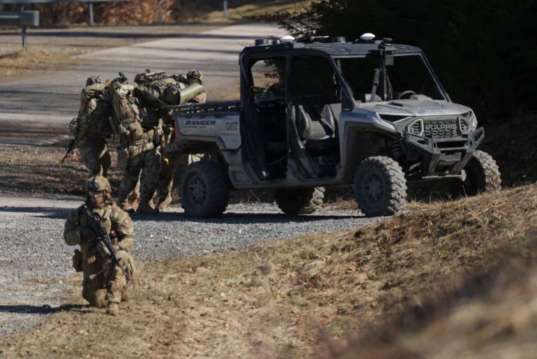 GRAFENWOEHR, GERMANY - MARCH 13: U.S. Army soldiers simulate the evacuation of a wounded comrade to a Polaris vehicle equipped with Dataspeed remote driving abilities during a demonstration of capabilities at the xTech Edge Strike: Ground robotics technology evaluation of the U.S. Army at the Grafenwoehr training grounds on March 13, 2026 near Grafenwoehr, Germany. The U.S. Army 2nd Cavalry Regiment has been hosting the competition, in which soldiers have been testing unmanned ground vehicles (UGVs) from a variety of manufacturers in realistic scenarios since March 3 to assess future procurement options of ground-based drones for the U.S. Army. (Photo by Sean Gallup/Getty Images)