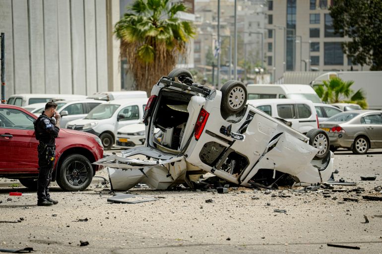 getty_69d1321121-1775317521 TEL AVIV, ISRAEL - APRIL 4: A car which was destroyed and flipped over after an impact in a parking lot on April 04, 2026 in Tel Aviv, Israel. Iran has continued firing waves of drones and missiles at Israel after the United States and Israel launched a joint attack on Iran early on February 28th. (Photo by Erik Marmor/Getty Images)