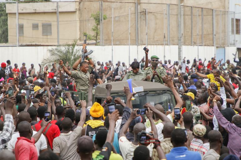 BAMAKO, MALI - AUGUST 18: Crowds cheer as soldiers parade in vehicles along the Boulevard de l'Independance on August 18, 2020 in Bamako, Mali. President Ibrahim Boubacar Keita and Prime Minister Boubou Cisse have been taken captive by mutinying soldiers, according to multiple news reports. Their arrest was preceded by a takeover the Kati military camp, about 15km from Bamako.(Photo by John Kalapo/Getty Images)