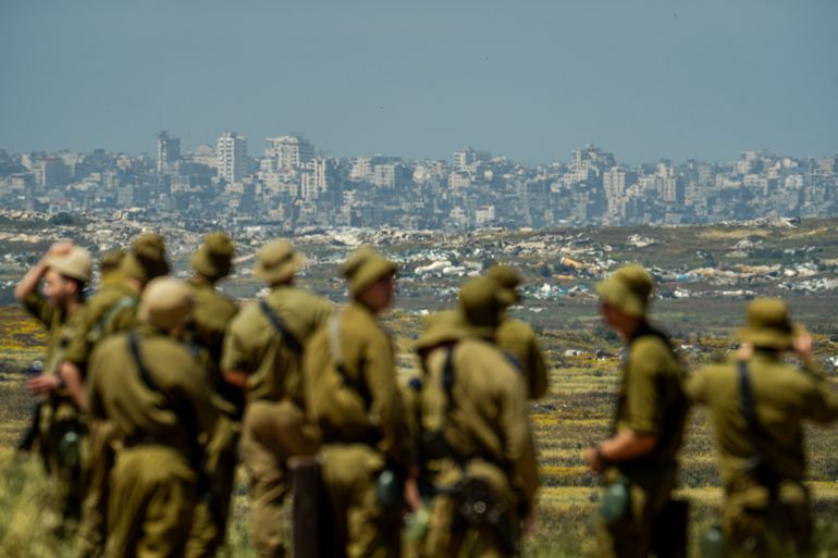 KIBBUTZ NIR AM, ISRAEL - APRIL 22: Israeli soldiers looking at the destroyed city of Jabalia, in Gaza Strip, near Kibbutz Nir Am during independence day (Yom Ha'atzmaut) commemorations on April 22, 2026 in Kibbutz Nir Am, Israel. (Photo by Erik Marmor/Getty Images)