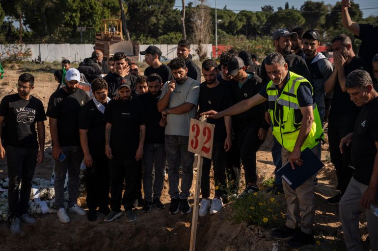 TYRE, LEBANON - APRIL 30: Mourners gather during a funeral at a makeshift cemetery for Hussein Ghadbouni, who was killed in an Israeli airstrike, on April 30, 2026 in Tyre, Lebanon. The Lebanese Ministry of Health confirmed three members of the Lebanese Civil Defense were killed in an Israeli airstrike on Tuesday while responding to an initial strike on a building in the southern town of Majdal Zoun. The successive strikes killed nine people total and wounded 17 others. (Photo by Adri Salido/Getty Images)