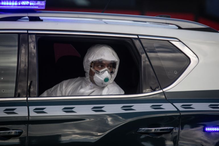 TENERIFE, SPAIN - MAY 11: A member of the Guardia Civil sits in a car during the evacuation of passengers from the MV Hondius after docking in the Granadilla Port on May 11, 2026 in Tenerife, part of the Canary Islands, Spain. The cruise ship MV Hondius, which had three passengers die from Hantavirus last month and eight more reported cases, docked in Tenerife on May 10th, where the remaining passengers are being repatriated to their respective countries. At a press conference this week, representatives of the World Health Organization (WHO) emphasized the outbreak of this rare virus did not constitute a pandemic, but it has stirred anxieties in the Canary Islands and elsewhere. (Photo by Chris McGrath/Getty Images)