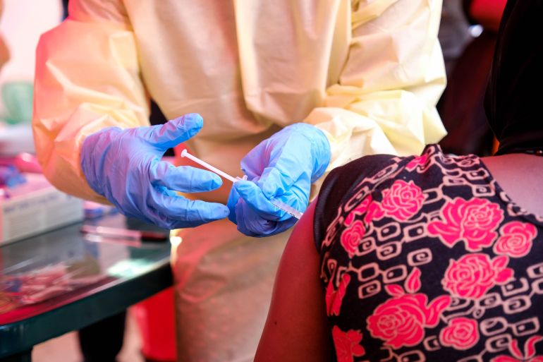 KAMPALA, UGANDA - FEBRUARY 3: A member of a medical team at Mulago Referral Hospital administers a dose of a trial vaccine to a patient, on February 3, 2025, in Kampala, Uganda. A trial vaccine is being made available for hospital workers and contacts of a man who died after testing positive for the Sudan strain of the Ebola virus last week. The Uganda Ministry of Health declared an outbreak of Sudan virus disease (SVD) on January 30, following the death of the 32-year-old male nurse who worked at the Mulago Referral Hospital, marking the first recorded fatality from Ebola since the last outbreak in Uganda, between 2022-2023. Sudan virus is a deadly strain of Ebola, and according to the World Health Organization, currently has no approved treatments or vaccines. (Photo by Hajarah Nalwadda/Getty Images)