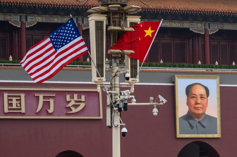 getty_6a0baa9841-1779149464 BEIJING, CHINA - MAY 14: American and Chinese flags fly near a portrait of the late Mao Zedong at Tiananmen Gate on May 14, 2026 in Beijing, China. President Donald Trump arrived in Beijing on May 13th for a two-day summit with Chinese President Xi Jinping. It is the first visit to China by a U.S. President since Trump's last visit in 2017. (Photo by Kevin Frayer/Getty Images)