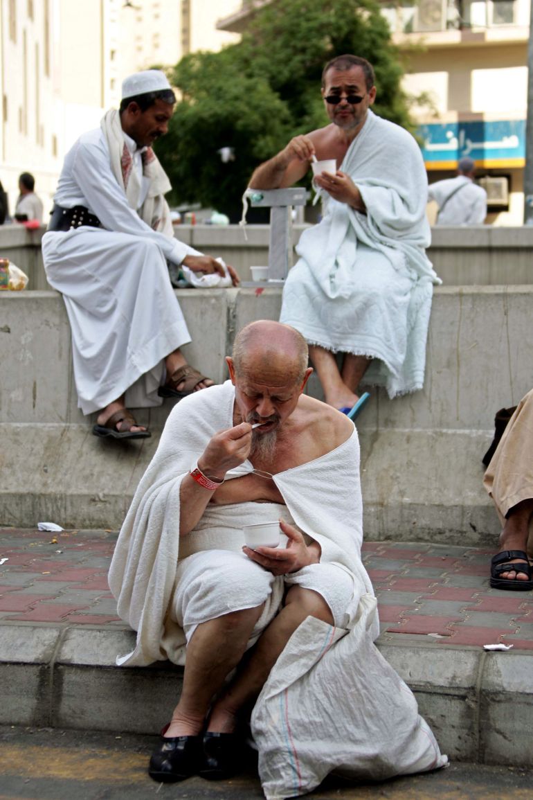 MECCA, SAUDI ARABIA - JANUARY 14: A Muslim pilgrim eats ice-cream January 14, 2005 in the courtyard of the holiest Al-Ka'aba mosque after a busy holy day for Friday prayer and jogging around the Al-Ka'aba mosque in the holy city of Mecca, Saudi Arabia. Around two million Muslim pilgrims around the world attended the Friday prayer seven days before the holiest Muslim day of Al-Hajj or Bilgirame Day. (Photo by Abid Katib/Getty Images)