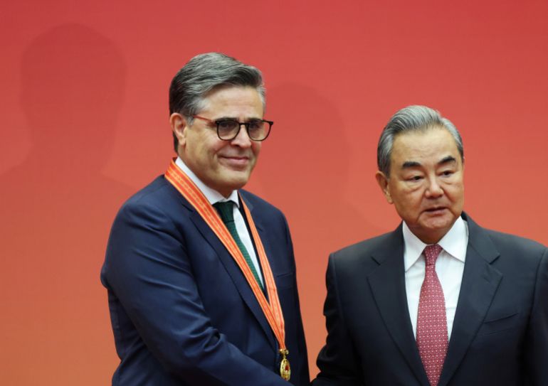 getty_6a1543e66d-1779778534 BEIJING, CHINA - MAY 18: China's Foreign Minister Wang Yi and Pakistan's Ambassador to China Khalil Hashmi pose for photographers during for the presentation ceremony for the Outstanding Diplomat Medal of the Foreign Ministry of China on May 18, 2026 in Beijing, China. (Photo by Maxim Shemetov - Pool/Getty Images)