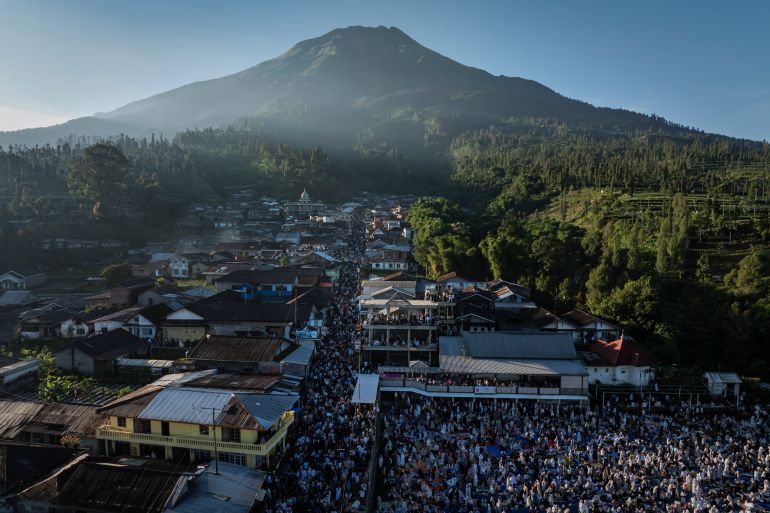 UNSPECIFIED, INDONESIA - MAY 27: An aerial view as Indonesian Muslims gather after Eid al-Adha prayers with Mount Sumbing in the background at Butuh village on May 27, 2026 in Wonosobo, Central Java, Indonesia. Muslims worldwide celebrate Eid Al-Adha to commemorate the Prophet Ibrahim's readiness to sacrifice his son as a sign of his obedience to God, during which they sacrifice permissible animals, generally goats, sheep, and cows. (Photo by Ulet Ifansasti/Getty Images)