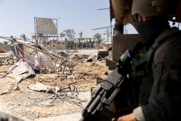 KHAN YUNIS, GAZA - JUNE 8: (EDITOR'S NOTE: Image has been reviewed by Israeli Defense Forces prior to transmission) An Israeli soldier guards as he sits in an army vehicle while escorting members of the press towards Gaza European Hospital near Khan Yunis on June 8, 2025 in Khan Yunis, Gaza. According to the Israeli military, it struck Hamas "underground infrastructure" beneath the European Hospital on May 13, reportedly killing Hamas chief Muhammad Sinwar, younger brother of the militant group's former leader, Yahya Sinwar, who was killed by Israeli forces last year. The Hamas-run civil defence said that during the strike six bombs hit the hospital's inner courtyard and surrounding area, killing 28 people and injuring dozens more. The IDF alleges tunnels under the European Hospital in southern Gaza were used by Hamas as a command center during the October 7, 2023 Hamas attack on Israel, masterminded by Yahya Sinwar. Hamas has not yet confirmed or denied Muhammad Sinwar's death. (Photo by Amir Levy/Getty Images)