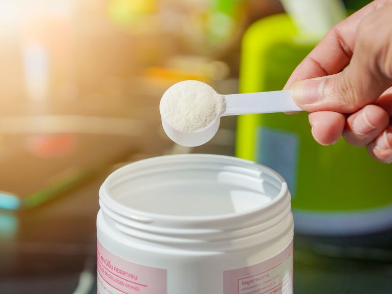 gettyimages-2200399456-1760534101 Lifestyle Health care. Hands of a person scooping collagen powder from a jar with a scoop. Collagen, which contains vitamins, helps nourish, anti age and restore the body's deterioration.