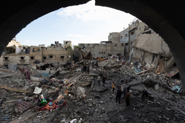 ghzt-2-1779788419 NUSEIRAT, GAZA, PALESTINE - MAY 26: Local residents inspect the destroyed building and the damaged houses following the Israeli strike on a building belonging to the Tawil family in the Nuseirat Refugee Camp in Gaza, Palestine on May 26, 2026. The building was completely destroyed in the attack, while nearby homes were also damaged. Residents went through the rubble to find their belongings. ( Mahmoud Abu Hamda - Anadolu Agency )