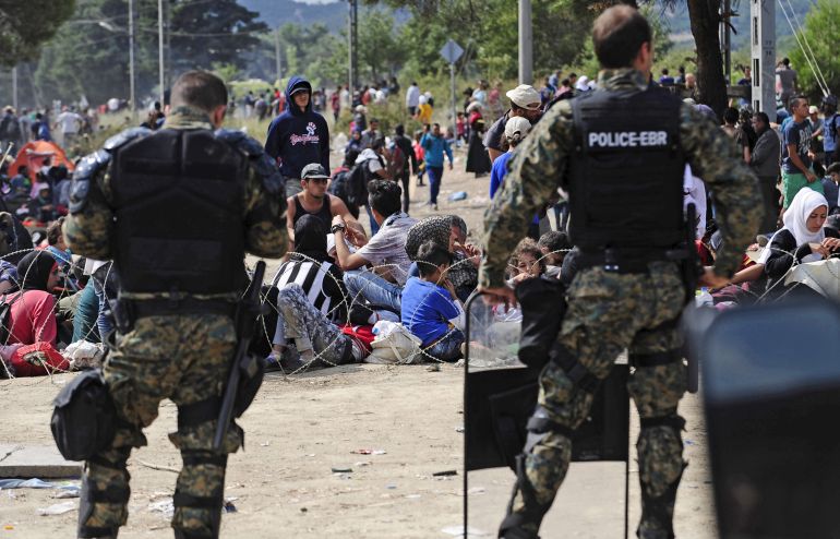 immigration-to1-1779190846 Macedonian special policemen guard the border as more than a thousand immigrants wait at the border line of Macedonia and Greece to enter Macedonia near the Gevgelija railway station August 21, 2015. Macedonian police drove back crowds of migrants and refugees trying to enter from Greece on Friday after a night spent stranded in no-man's land by an emergency decree effectively sealing the Macedonian frontier. REUTERS/Ognen Teofilovski