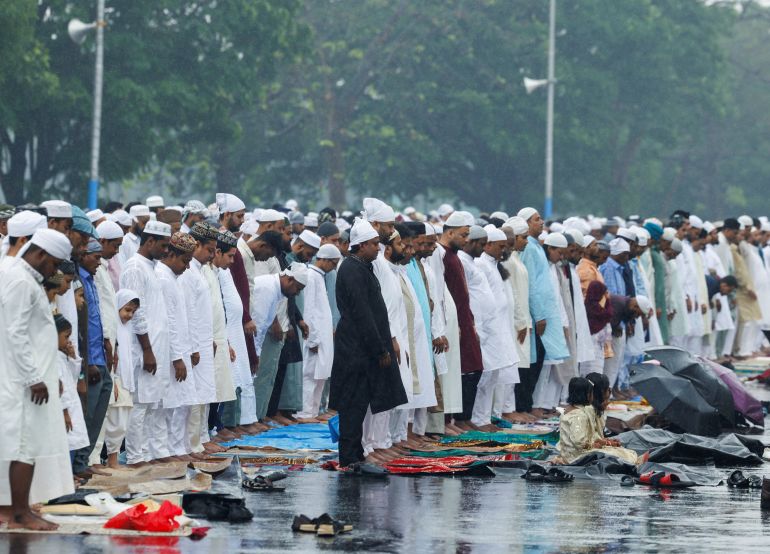 Muslims offer prayers as it drizzles on the occasion of Eid al-Fitr to mark the end of the holy fasting month of Ramadan, on a road in Kolkata, India, March 21, 2026. REUTERS/Sahiba Chawdhary