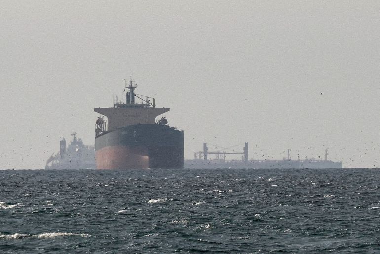 FILE PHOTO: Cargo ships in the Gulf, near the Strait of Hormuz, as seen from northern Ras al-Khaimah, near the border with Oman’s Musandam governance, amid the U.S.-Israeli conflict with Iran, in United Arab Emirates, March 11, 2026./File Photo
