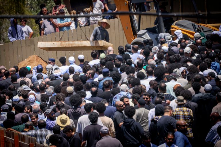 SAN DIEGO, CALIFORNIA - MAY 21: People attend the funeral service for Amin Abdullah, Mansour Kaziha, and Nadir Awad, at La Vista Memorial Park in National City on May 21, 2026 in San Diego, California. The services honor the three men who were killed trying to stop two teenage gunmen from entering the Islamic Center of San Diegos mosque and school. Sandy Huffaker/Getty Images/AFP (Photo by Sandy Huffaker / GETTY IMAGES NORTH AMERICA / Getty Images via AFP)