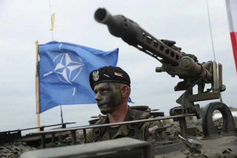 nato-1-1779377556 A soldier of the Polish Army sits in a tank as a NATO flag flies behind during the NATO Noble Jump military exercises of the VJTF forces on June 18, 2015 in Zagan, Poland. Sean Gallup/Getty Images