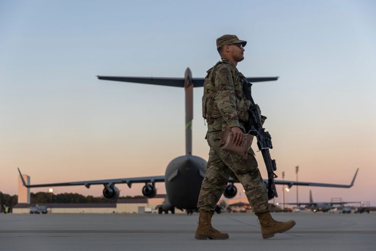 natos-5-1779376031 Members of the 82nd Airborne Division of the U.S. Army walk on the tarmac at Pope Field ahead of deployment to Poland from Fort Bragg, N.C. on Monday, Feb. 14, 2022. They are among soldiers the Department of Defense is sending in a demonstration of American commitment to NATO allies worried at the prospect of Russia invading Ukraine. (AP Photo/Nathan Posner)