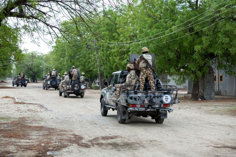 pic-887744114-1778943724 Nigerian soldiers from the Multinational Joint Task Force (MNJTF) drive around in pick-ups during training at the MNJTF military base, Sector 3 Headquarters, in Monguno, Borno state, Nigeria, on July 5, 2025. Twelve checkpoints manned by the Nigerian army control the various entrances to Monguno. Monguno's huge fortifications have kept the garrison town mostly secure even as northeastern Nigeria has seen a recent surge in attacks on military bases by jihadists fighting a grinding 16 year war. Fighting in Borno may have eased since the conflict's highpoint in 2015 as jihadists have been forced back. But militants from Islamic State West Africa Province or rival Boko Haram have attacked or temporarily overrun a dozen military bases since the start of the year. (Photo by Joris Bolomey / AFP)