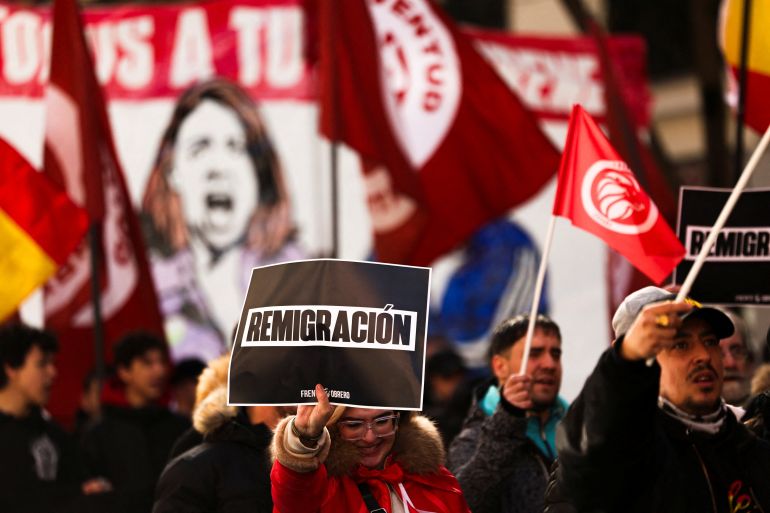 Demonstrators take part in a protest called by Spain's nationalist, anti-migration party, Workers' Front, outside the headquarters of the ruling Spanish Socialist Workers' Party (PSOE) to oppose a plan to fast-track legal status for undocumented migrants, in Madrid, Spain, February 8, 2026. REUTERS/Violeta Santos Moura