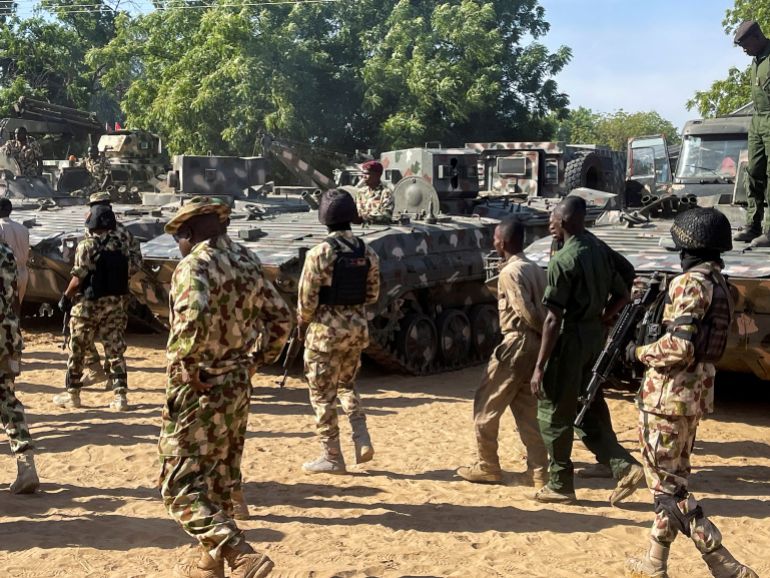 reuters_69da4f9d-1775914909 FILE PHOTO: Nigerian soldiers walks past military tanks prepared for deployment during a tour of the Theatre Command Operation Lafiya Dole by Nigeria's Chief of Army Staff at Maimalari Cantonment in Maiduguri, Borno State, Nigeria, November 7, 2025. REUTERS/Ahmed Kingimi/File Photo