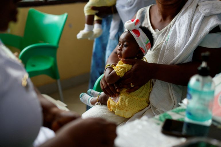 FILE PHOTO: An infant waits to receive a dose of the RTS,S malaria vaccine, also known as Mosquirix, at the Mother and Child Hospital in Kasoa, Ghana, November 19, 2025. REUTERS/Francis Kokoroko/File Photo