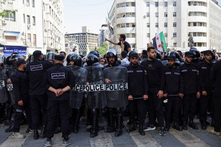 Police officers stand guard during the 'Law and Dignity' protest, organised by activists calling for better living conditions, improved security, and respect for citizens' rights, at Yousef Al-Azmeh Square, in Damascus, Syria, April 17, 2026. REUTERS/Khalil Ashawi