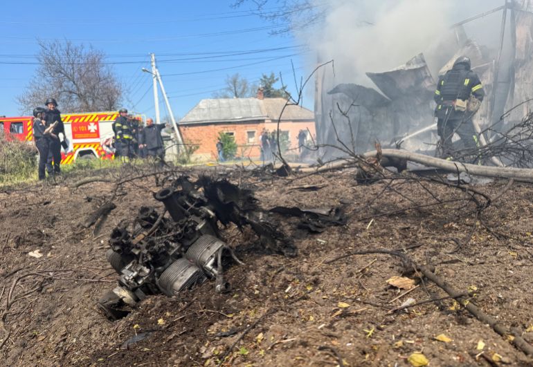 An engine of a Russian drone lays on the ground as rescuers work at the site of a Russian drone strike, amid Russia's attack on Ukraine, in Kharkiv, Ukraine May 7, 2026. Picture taken with a mobile phone. REUTERS/Vitalii Hnidyi