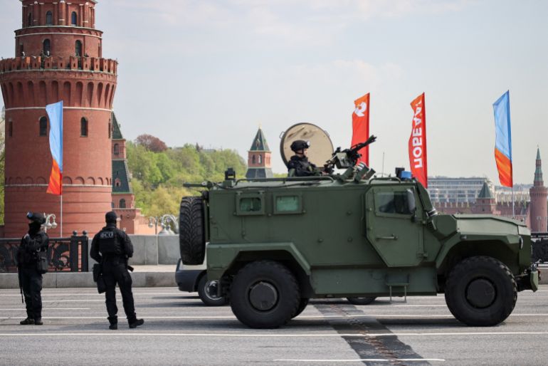 reuters_69fdc0ec-1778237676 Russian security personnel stand next to an all-terrain infantry mobility vehicle amid increased security measures taken ahead of Victory Day, marking the anniversary of victory over Nazi Germany in World War Two, on the Bolshoi Kamenny Bridge near the Kremlin in central Moscow, Russia, May 7, 2026. REUTERS/Stringer TPX IMAGES OF THE DAY