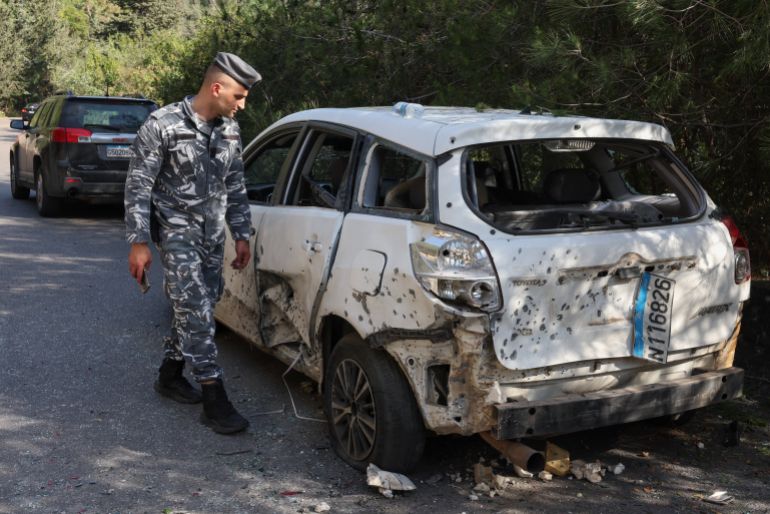 A member of the army walks next to a damaged car following an Israeli strike in the Damour area, Lebanon, May 9, 2026. REUTERS/Mohamed Azakir