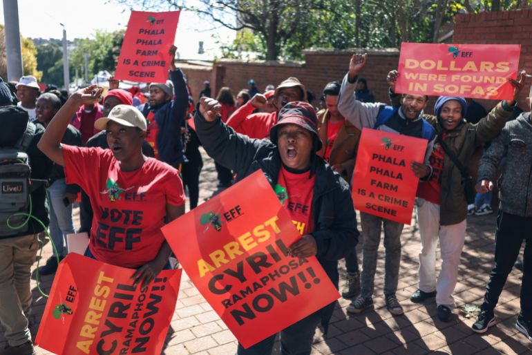 Supporters of the Economic Freedom Fighters (EFF) carry placards outside South Africa's Constitutional Court, after the Court ruled on whether the parliament failed to hold President Cyril Ramaphosa to account over the "Farmgate" scandal, involving allegations that foreign currency was hidden at his Phala Phala game farm, in Johannesburg, South Africa, May 8, 2026. REUTERS/Siphiwe Sibeko