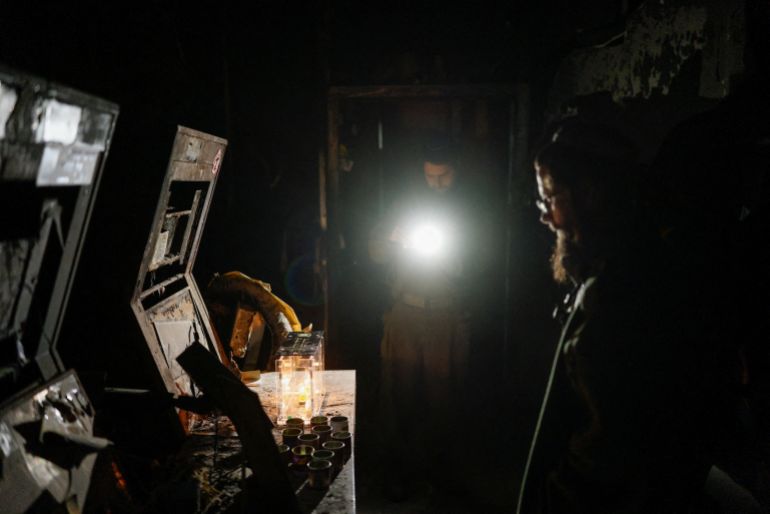 Israeli soldiers gather for the lighting of a candle on a menorah marking the first night of the Jewish holiday of Hanukkah, at Nahal Oz military base, in southern Israel, December 14, 2025. The base was attacked during the deadly October 7, 2023 attack by Hamas and female soldiers were taken hostage to Gaza. REUTERS/Amir Cohen REFILE - CORRECTING YEAR OF ATTACK FROM "2033" TO "2023" .