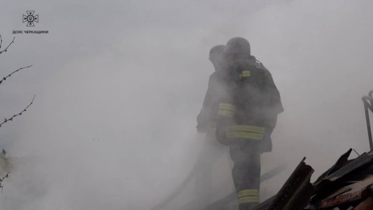 Firefighters work at the site of a Russian drone strike in which three men were injured, amid Russia's attack on Ukraine, at a location given as Smila, Cherkasy region, Ukraine, in this still image taken from a video released on May 13, 2026. State Emergency Service of Ukraine/Handout via REUTERS ATTENTION EDITORS - THIS IMAGE HAS BEEN SUPPLIED BY A THIRD PARTY. VERIFICATION LINES: Reuters was not able to independently verify the location or the date when the footage was filmed but the governor of Cherkasy Region said in a statement on Telegram that Smila was targeted in a Russian drone attack, injuring three.