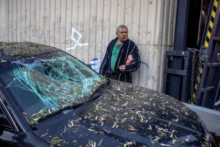 reuters_6a0aa10d-1779081485 A resident, Serhii, who was injured by shrapnel, stands by his damaged car outside an apartment building that was struck and partially collapsed during Russian missile and drone strikes, amid Russia's attack on Ukraine, in Kyiv, Ukraine, May 14, 2026. REUTERS/Thomas Peter TPX IMAGES OF THE DAY