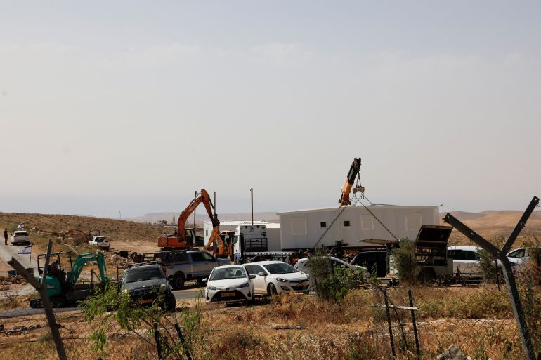 reuters_6a107e5e-1779465822 Israeli settlers install a new caravan near the Palestinian village of Um Al-Khair in Masafer Yatta in the Israeli-occupied West Bank, May 20, 2026. REUTERS/Mussa Qawasma
