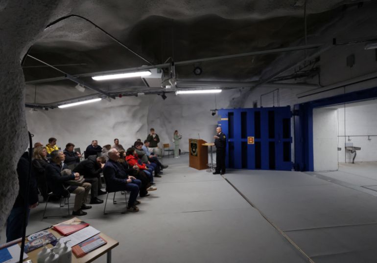 reuters_6a13645f-1779655775 Jukka-Pekka Schroderus from the City of Helsinki rescue department speaks with members of the Ukrainian Mayors' Club during a visit to the Merihaka civil shelter in Helsinki, Finland, May 6, 2026. REUTERS/Leonhard Foeger
