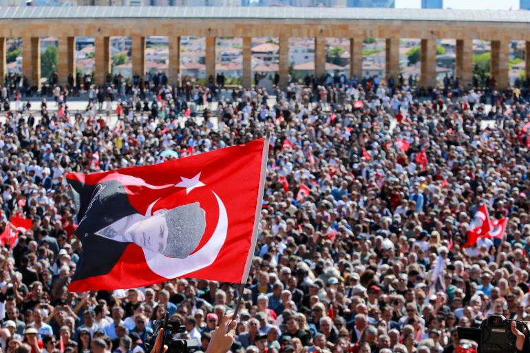A person waves a flag of Turkey featuring a picture of modern Turkey’s founder Mustafa Kemal Ataturk as supporters of Ozgur Ozel, the ousted chairman of the main opposition Republican People’s Party (CHP), visit the mausoleum of Mustafa Kemal Ataturk in Ankara, Turkey, May 30, 2026. REUTERS/Efekan Akyuz