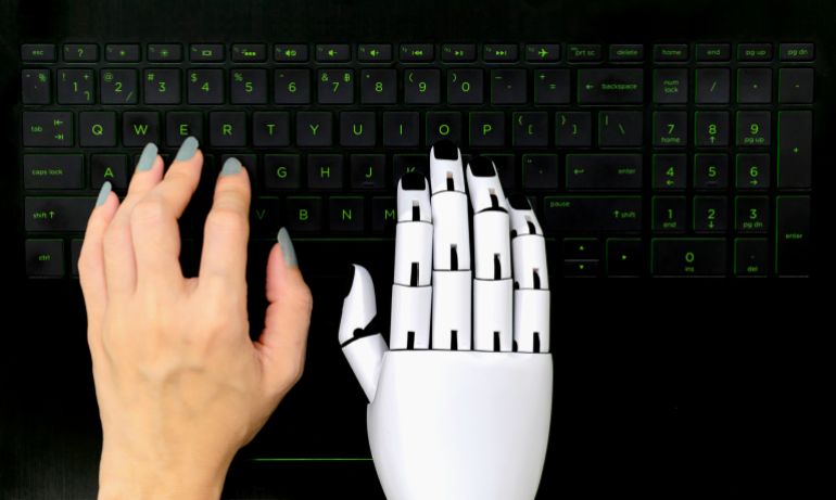 Robot concept chatbot of Human hand and robot hand pressing computer keyboard enter