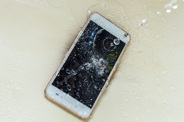 Phone in the water. Concept broken phone. Smartphone repair concept
