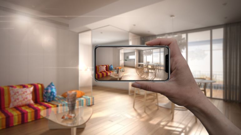Hand holding smart phone, AR application, simulate furniture and interior design products in real home, architect designer concept, blur background, modern colored living room, 3d illustration