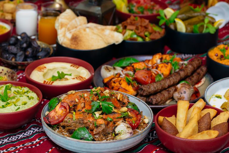 shutterstock_1947073975-1779284878 Ramadan Iftar table with food