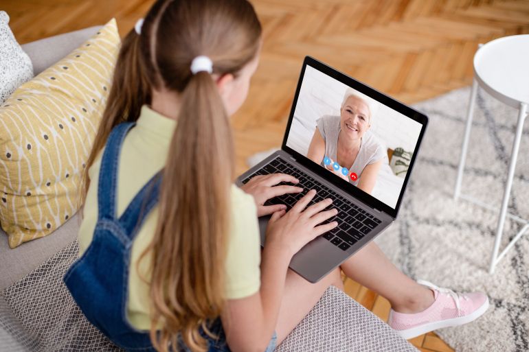 Online Call. Little Girl Using Laptop For Video Chat With Grandmother, Unrecognizable Female Child Having Virtual Meeting With Senior Woman While Sitting On Couch At Home, Creative Collage