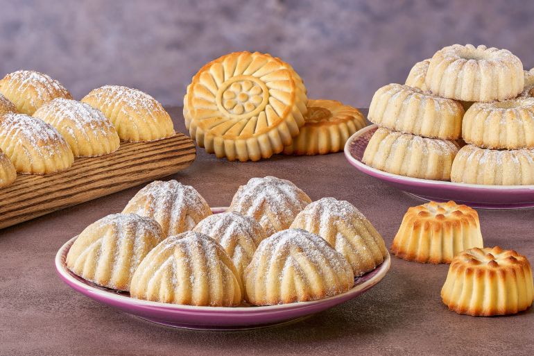 Assorted semolina maamoul or mamoul cookies with dates , walnuts and pistachio nuts. Traditional arabic Eid al Adha, Eid al Fitr sweets. Close up