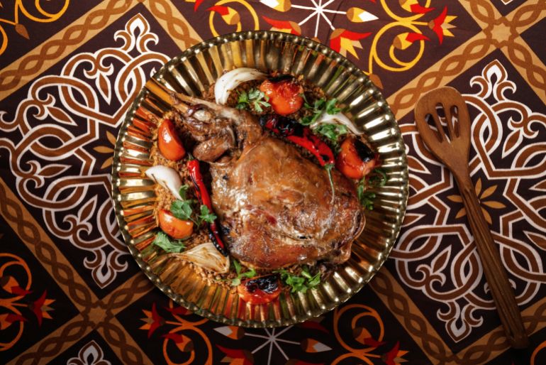 shutterstock_2211111039-1772455483 Mandi is a traditional dish from Saudi of meat, rice, and spices.