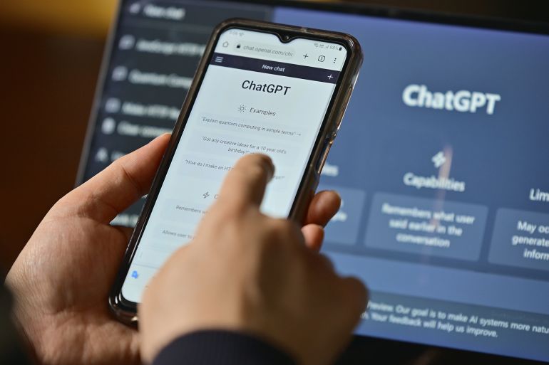 Seoul, South Korea - February 12, 2023 : Computer screen with ChatGPT website and person using mobile phone to ask questions to ChatGPT; Shutterstock ID 2400648421; purchase_order: aj; job: ; client: ; other: