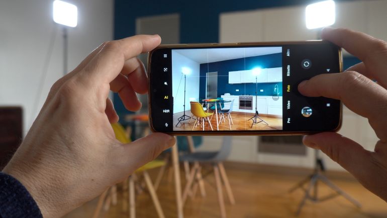 Real estate photographer taking pictures and videos at house in apartment living room with mobile phone - selling home with real estate agency and home staging indoor home design - AI