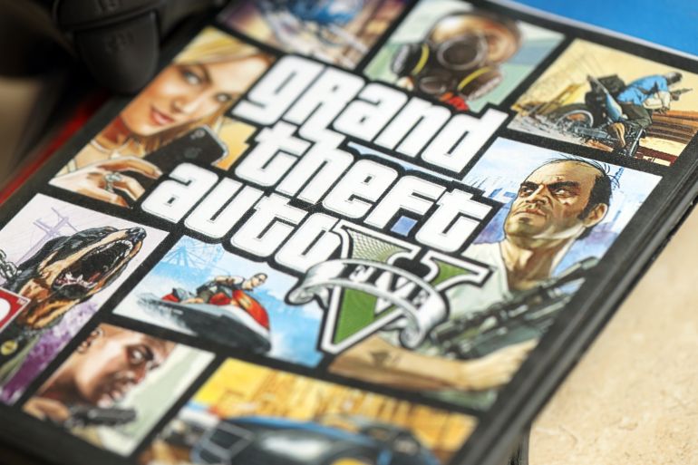 KYIV, UKRAINE - JUNE 26, 2024 Grand Theft Auto 5 PS4 video game disc box for console gaming. Popular video game disc close up