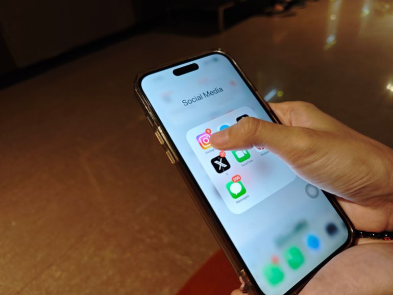 Kupang, Indonesia - October 17, 2024 : A person using a smartphone to access social media apps, showcasing modern communication and digital connectivity in everyday life